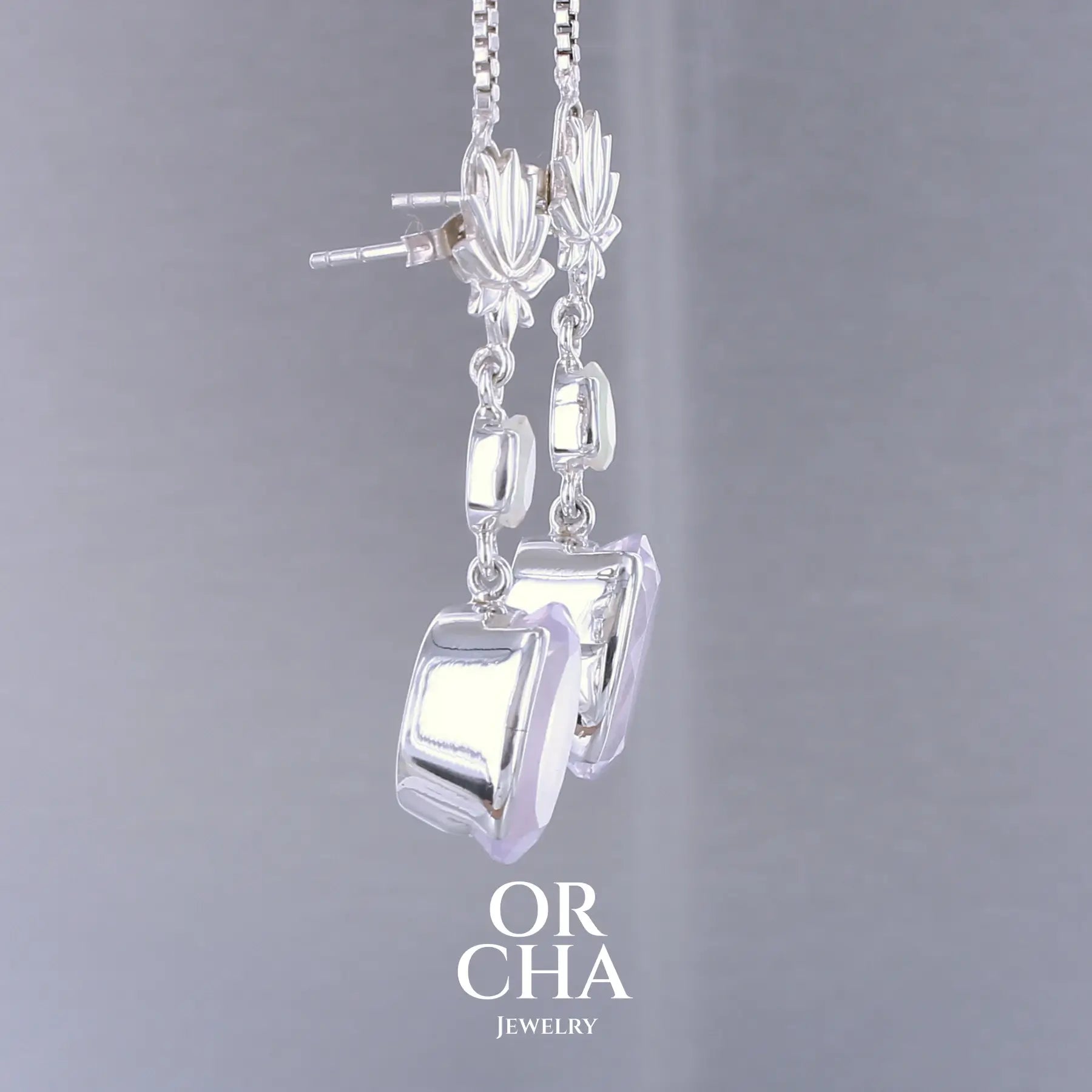 Boucles d'oreilles Lotus pour femme en argent massif sertie de Quartz lavandes et d'opales d'Éthiopie. Pierres facettées de forme ovales et de gouttes de qualités transparentes, propre à l'oeil. Pierres naturelles de couleurs violettes pastel teintées de rose avec des reflets opalescents et multicolores pour les opales . Bijoux unique, éthique et durable présenté dans un coffret de notre marque, prêt à offrir. Livraison offerte, certificat d'authenticité, service client.
