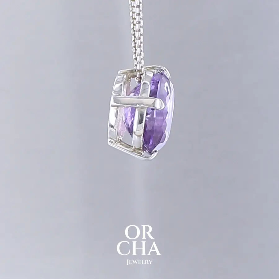 Collier solitaire pour femme en argent massif sertie d'une Améthyste. Pierre facettée de forme ovale de qualité transparente, inclusions. Pierre naturelle de couleur violet clair type rose de France. Pendentif monté sur une chaine en argent sterling de type maille vénitienne de 1,3 mm d'épaisseur et de 40 cm de longueur. Bijoux unique, éthique et durable présenté dans un coffret de notre marque, prêt à offrir. Livraison offerte, certificat d'authenticité, service client.