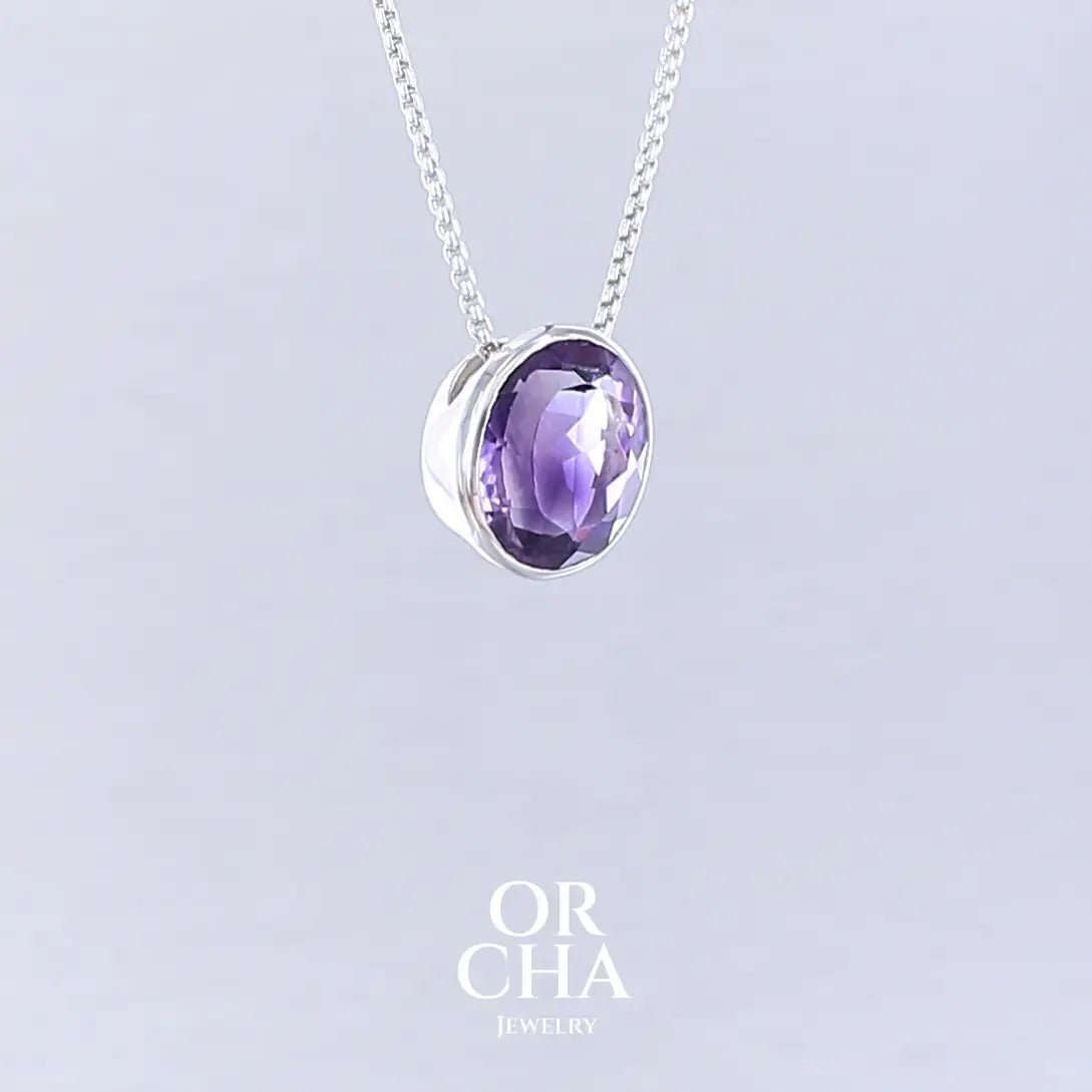 Collier solitaire pour femme en argent massif sertie d'une Améthyste. Pierre facettée de forme ovale de qualité transparente, propre à l'oeil. Pierre naturelle de couleur violet foncé à plus clair. Pendentif monté sur une chaine en argent sterling de type maille vénitienne de 1,3 mm d'épaisseur et de 40 cm de longueur. Bijoux unique, éthique et durable présenté dans un coffret de notre marque, prêt à offrir. Livraison offerte, certificat d'authenticité, service client.