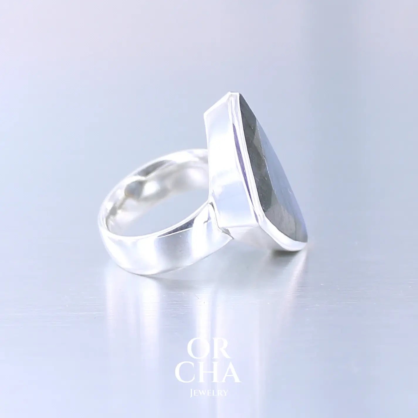 Profil de bague pour femme en argent massif sertie d'une labradorite aux reflets bleus nuit. Pierre facettée naturelle translucide présentant des inclusions fréquents sur ce type de pierre. Taille 58,5. Bijoux unique, éthique et durable présenté dans un coffret de notre marque, prêt à offrir. Livraison offerte, certificat d'authenticité, service client.