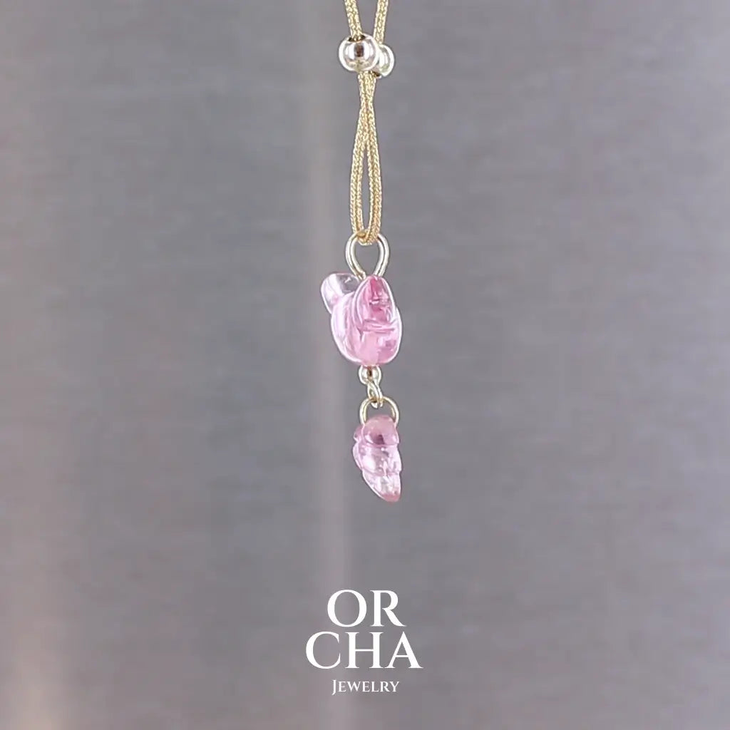 Collier pour femme orné d'une tourmaline rose sculptée à la main en 3 dimensions en forme d'oiseau et de feuille, serties en or 18k. Le pendentif est monté sur un collier corde doré scintillant, les apprêts utilisé sont en Gold filled ( or laminé ). Longueur ajustable de 40 cm à 45 cm. Bijoux unique, éthique et durable présenté dans un coffret de notre marque, prêt à offrir. Livraison offerte, certificat d'authenticité, service client.