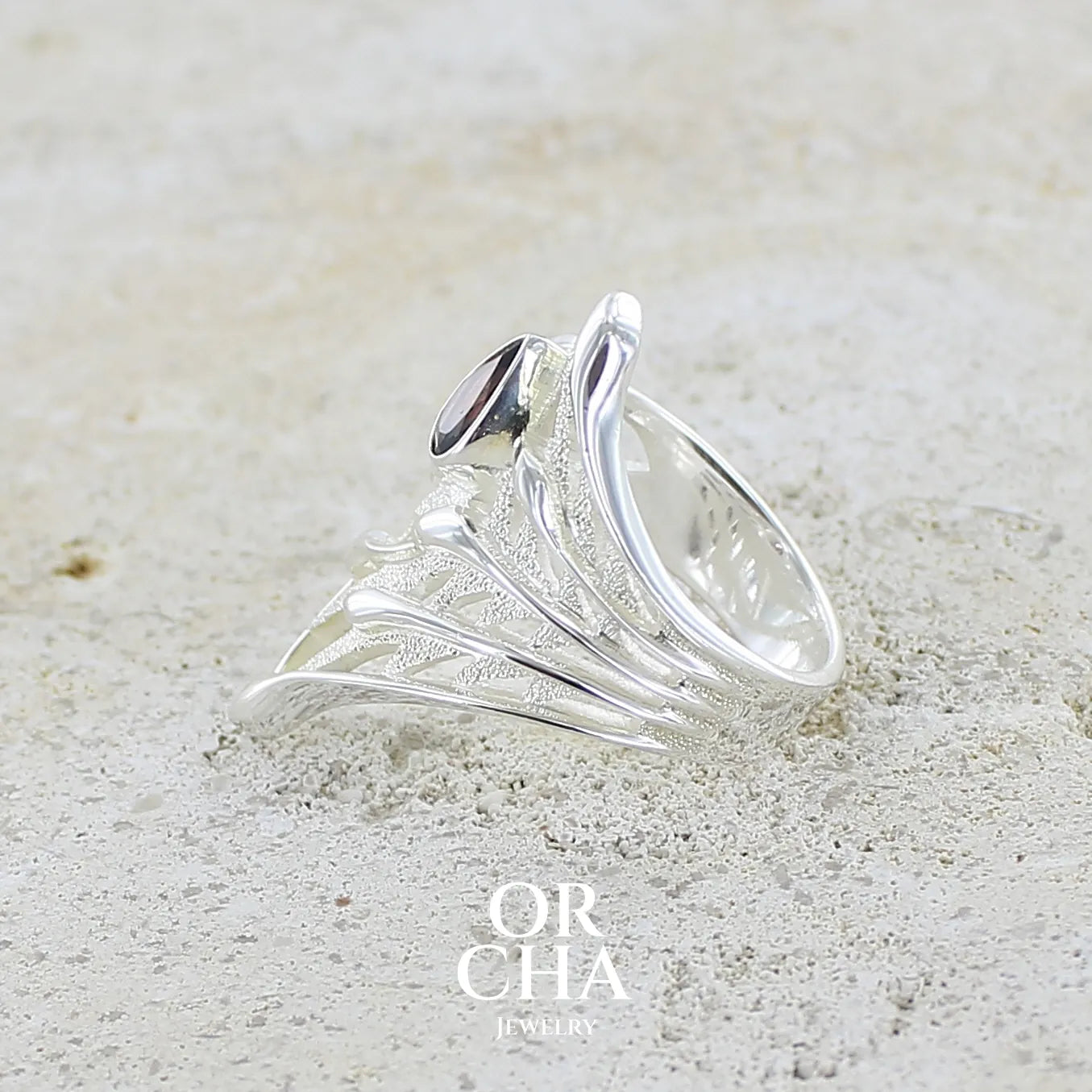 Détail d'une Grande Bague pour femme en argent massif, sertie d'une Tourmaline bicolore rose pêche et bleue nuit. Pierre facettée en forme de goutte. Pierre incolore, très lumineuse et propre à l'oeil. Bijoux unique au design de feuillage tropicale travaillé en filigrane réalisé en taille 54.