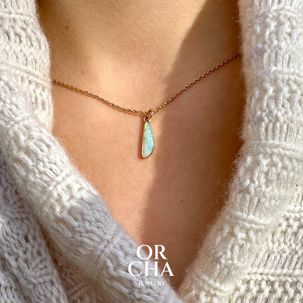Pendentif pour femme en or jaune massif 18k serti d'une opale cristal aux feux étoilés multicolores à dominantes vert turquoises. Cabochon de 1 carat taille en forme de goutte de qualité transparente. Bijou unique réalisé par Orchajewelry
