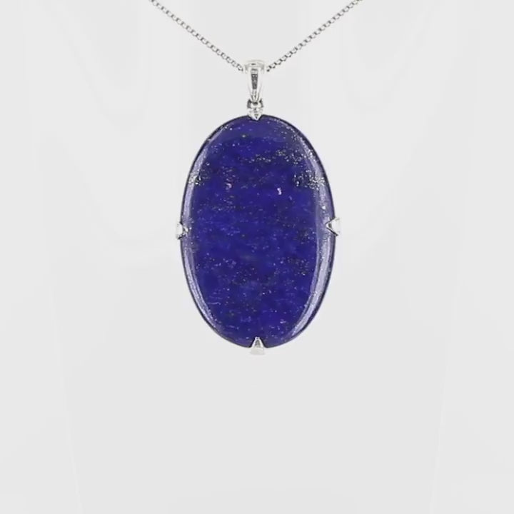 Grand pendentif ovale pour femme en argent massif serti d'un Lapis Lazuli. Pierre naturelle de couleur bleu nuit à inclusions de pyrite dorés, qualité opaque. Bijoux unique, éthique et durable présenté dans un coffret de notre marque, prêt à offrir. Livraison offerte, certificat d'authenticité, service client.