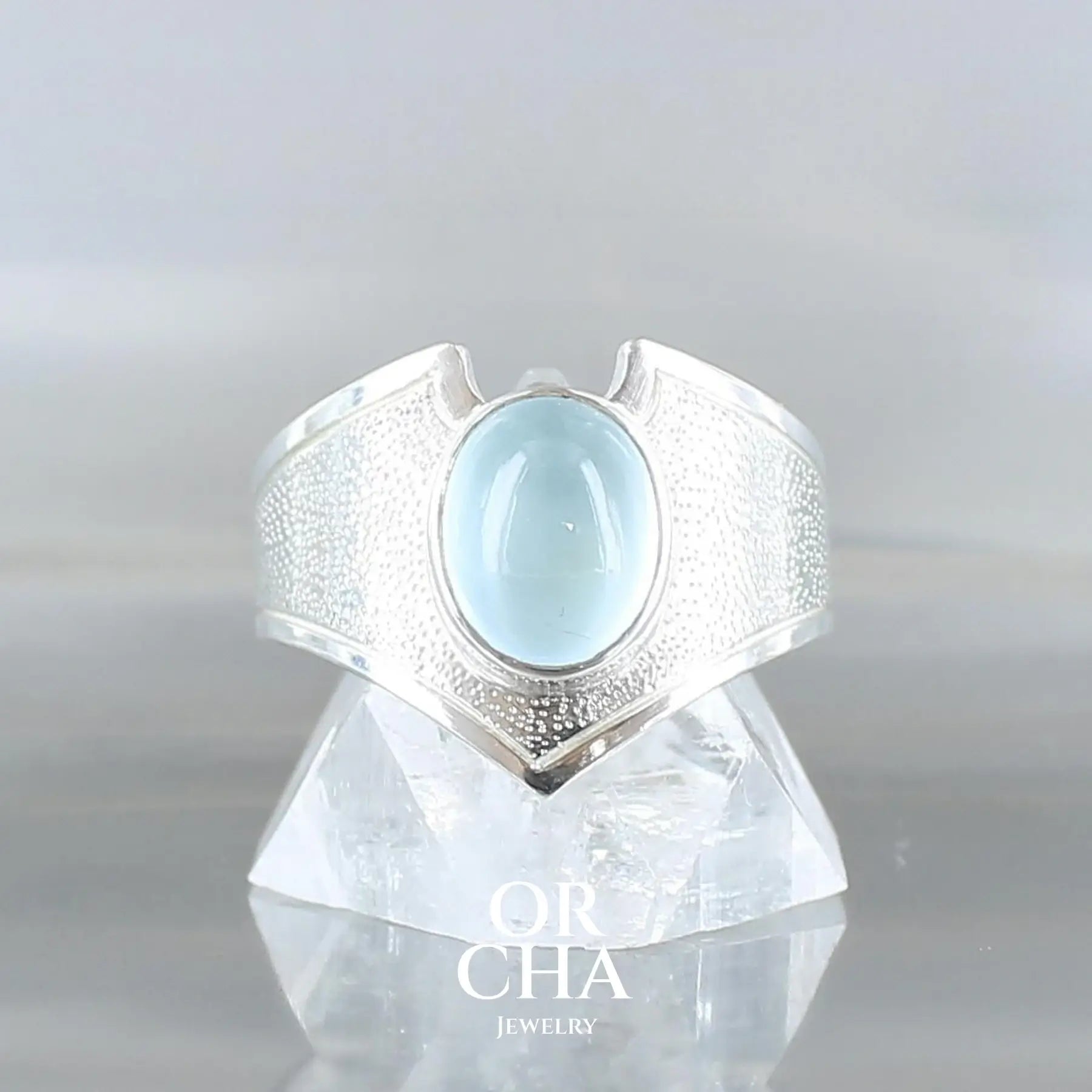 Bague de créateur d'inspiration elfique en argent massif, sertie d'un cabochon d'aigue-marine de 2,2 carats. Pierre fine naturelle, de couleur bleu ciel. Bijou unique, éthique et durable fabriqué à la main en taille 54, présenté dan sun coffret de notre marque, prêt à offrir. Certificat d'authenticité. Livraison offerte. 