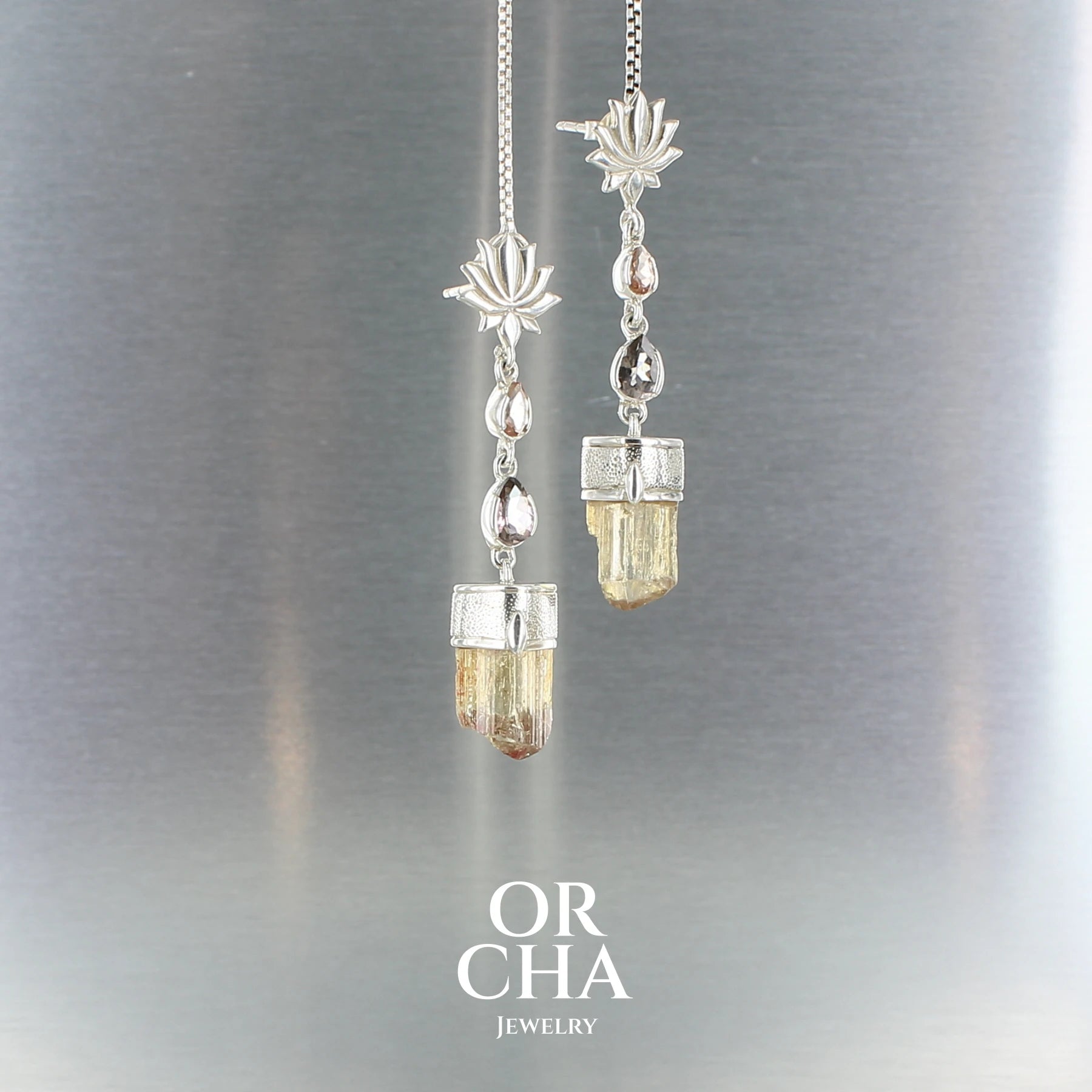 Boucles d’oreilles pendantes en argent : motif lotus au lobe, deux tourmalines (pêche et rose) et cristal brut de topaze impériale. Bijoux unique, éthique et durable présenté dans un coffret de notre marque, prêt à offrir. Livraison offerte, certificat d'authenticité, service client.
