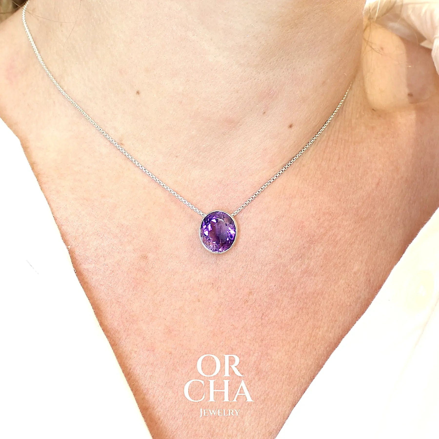 Collier solitaire pour femme en argent massif sertie d'une Améthyste. Pierre facettée de forme ovale de qualité transparente, propre à l'oeil. Pierre naturelle de couleur violet foncé à plus clair. Pendentif monté sur une chaine en argent sterling de type maille vénitienne de 1,3 mm d'épaisseur et de 40 cm de longueur. Bijoux unique, éthique et durable présenté dans un coffret de notre marque, prêt à offrir. Livraison offerte, certificat d'authenticité, service client.