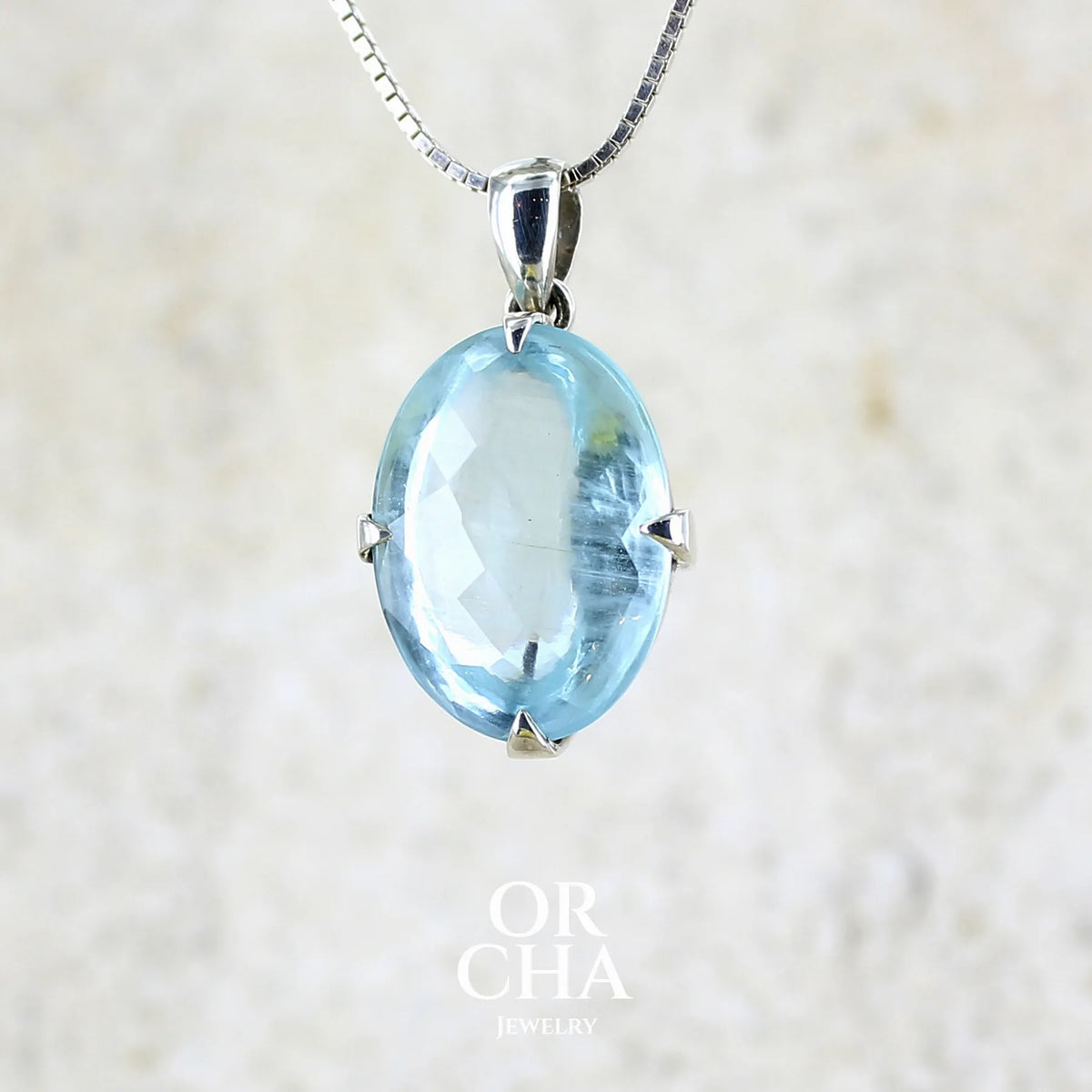 Pendentif  en argent massif sertie d'une aigue marine taillée de 17 carats de couleur bleu ciel lumineux. Pierre de forme ovale de qualité transparente comportant des inclusions. Bijoux unique réalisé par Orchajewelry