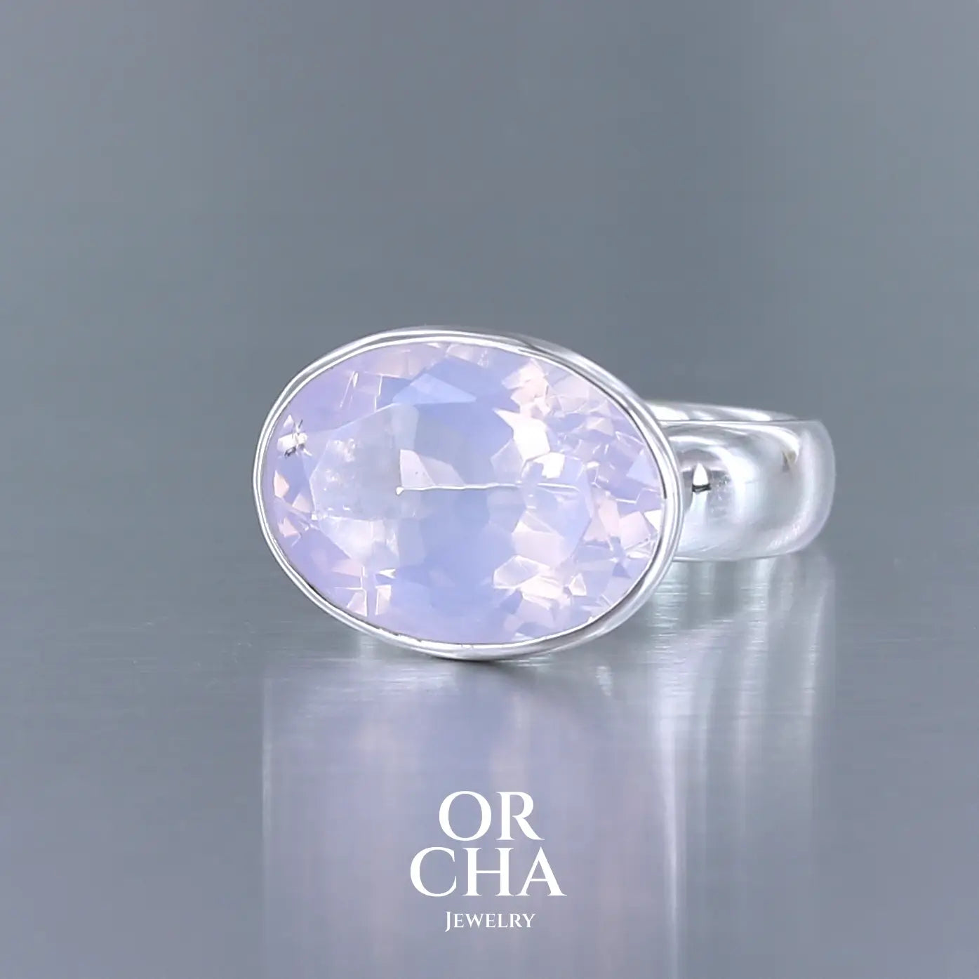 Bague cocktail pour femme en argent massif sertie d'un Quartz lavande. Pierre facettée de forme ovale de qualité transparente, propre à l'oeil. Pierre naturelle de couleur violette pastel teintée de rose avec de légers reflets opalescents. Bague réalisée en taille 56 . Bijoux unique, éthique et durable présenté dans un coffret de notre marque, prêt à offrir. Livraison offerte, certificat d'authenticité, service client.