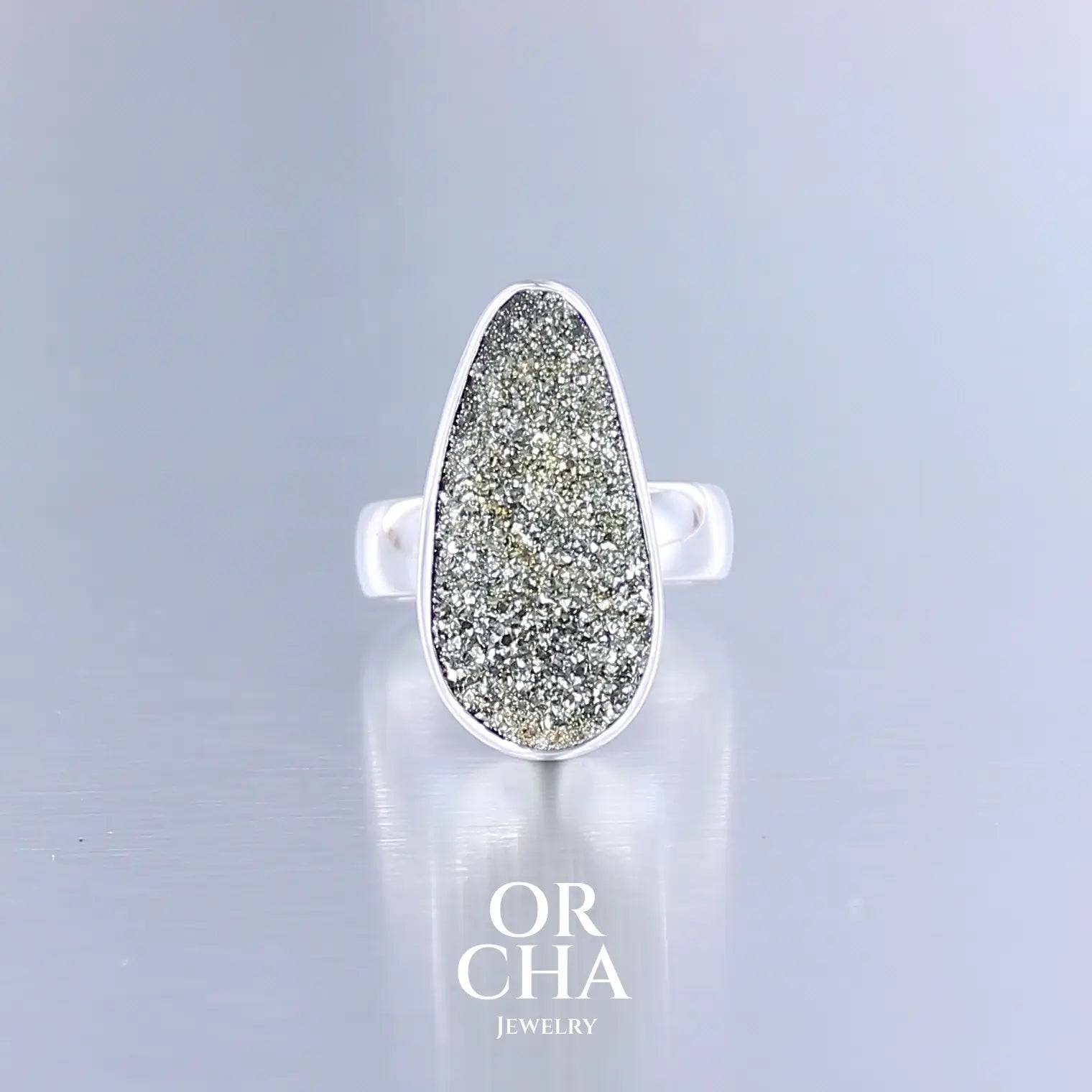 Bague pour femme en argent massif sertie d'une pyrite doré brute avec ses cristaux. Pierre qualité opaque taillée en forme de goutte. Pierre naturelle originaire du Russie de couleur doré scintillant. Bague réalisée en taille 54. Bijoux unique, éthique et durable présenté dans un coffret de notre marque, prêt à offrir. Livraison offerte, certificat d'authenticité, service client.