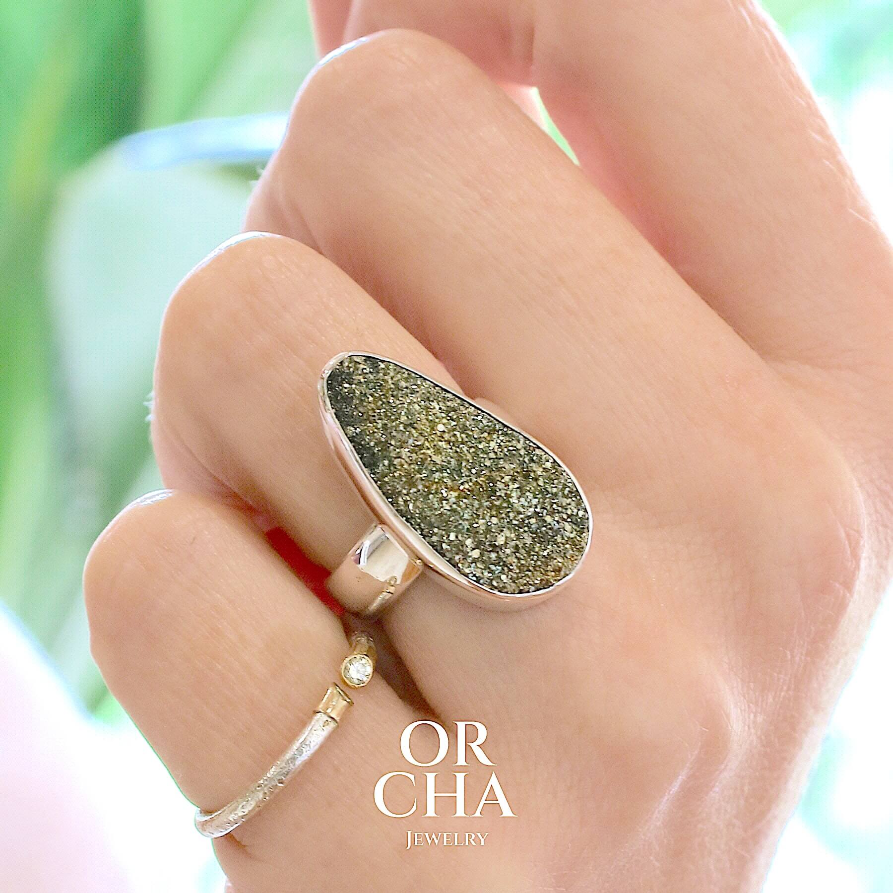 Bague pour femme en argent massif sertie d'une pyrite doré brute avec ses cristaux. Pierre qualité opaque taillée en forme de goutte. Pierre naturelle originaire du Russie de couleur doré scintillant. Bague réalisée en taille 54. Bijoux unique, éthique et durable présenté dans un coffret de notre marque, prêt à offrir. Livraison offerte, certificat d'authenticité, service client.