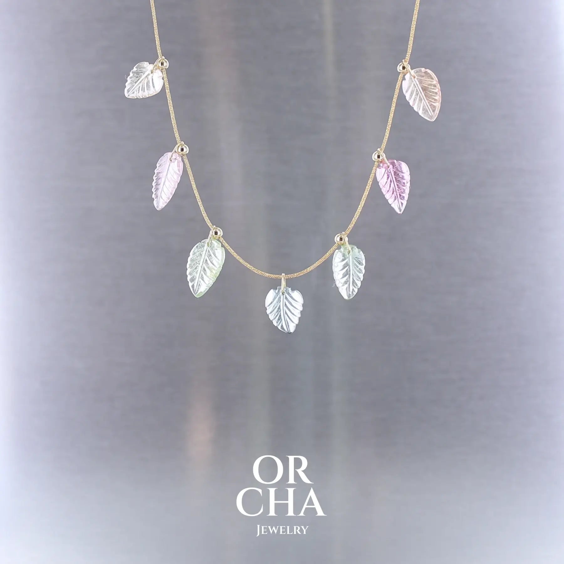 Collier pour femme orné de tourmalines roses, vertes, bleues et pêches, sculptées à la main en 3 dimensions en forme de feuilles et serties en or 18k. Les pendentifs sont montés sur un collier corde doré scintillant, les apprêts utilisé sont en Gold filled ( or laminé ). Longueur ajustable de 40 cm à 45 cm. Bijoux unique, éthique et durable présenté dans un coffret de notre marque, prêt à offrir. Livraison offerte, certificat d'authenticité, service client.