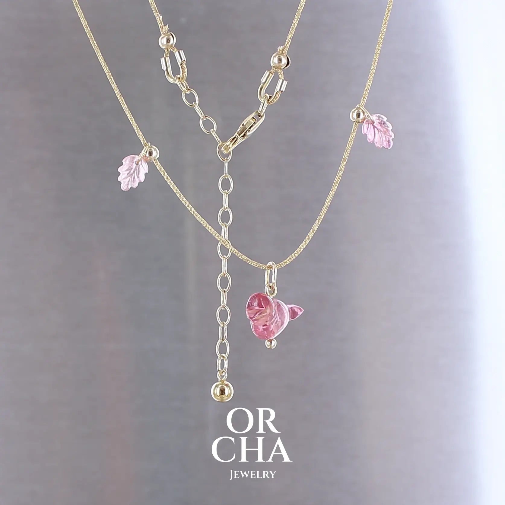 Collier pour femme orné de tourmalines roses sculptées à la main en 3 dimensions en forme d'oiseau et de feuilles, serties en or 18k. Les pendentifs sont montés sur un collier corde doré scintillant, les apprêts utilisé sont en Gold filled ( or laminé ). Longueur ajustable de 40 cm à 45 cm. Bijoux unique, éthique et durable présenté dans un coffret de notre marque, prêt à offrir. Livraison offerte, certificat d'authenticité, service client.