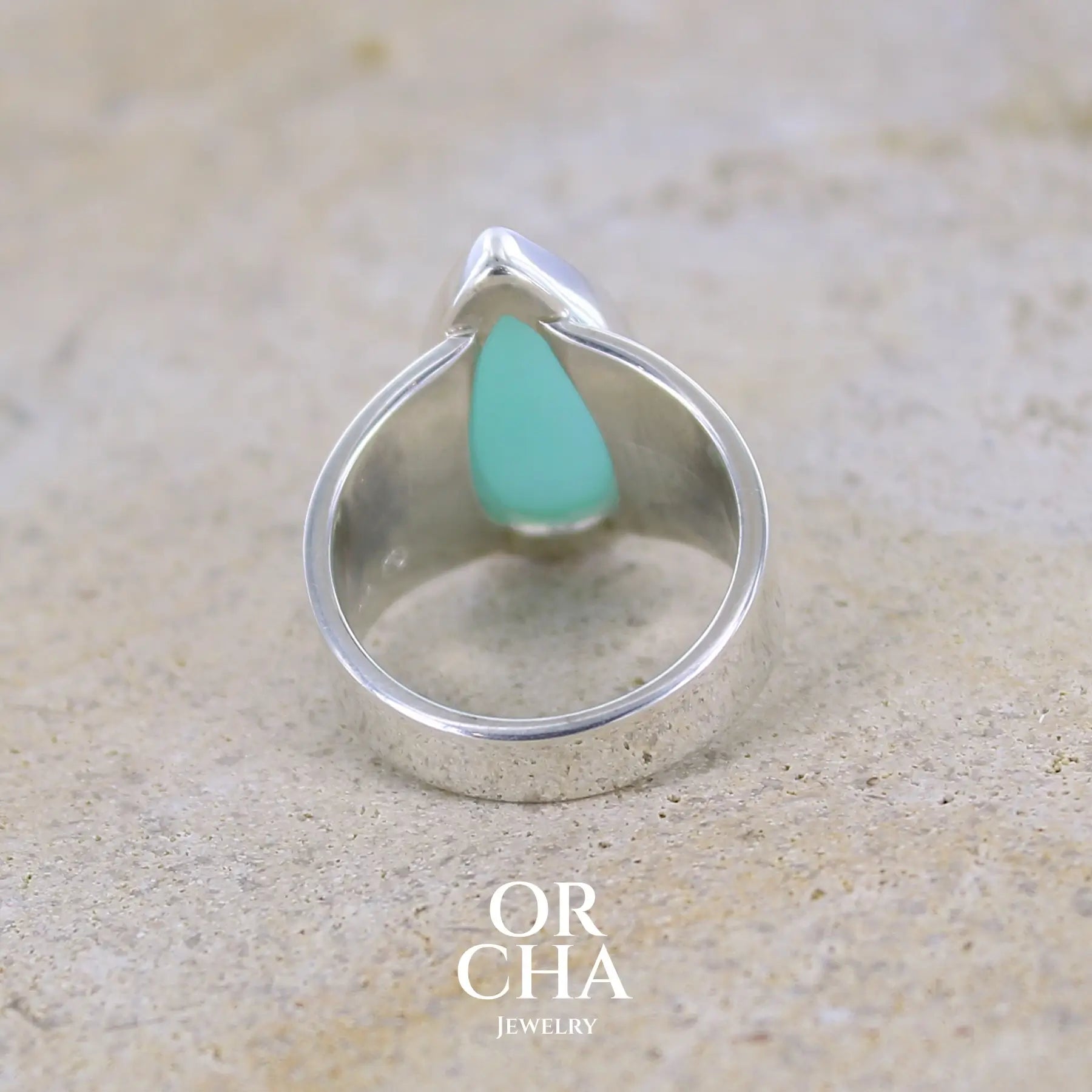 vue de dos d'une bague pour femme en argent massif, sertie d'un cabochon d'opale bleue du Pérou. Pierre taillée en forme de longue goutte. Pierre opaque. Taille 54. Bijoux unique, éthique et durable présenté dans un coffret de notre marque, prêt à offrir. Livraison offerte, certificat d'authenticité, service client.