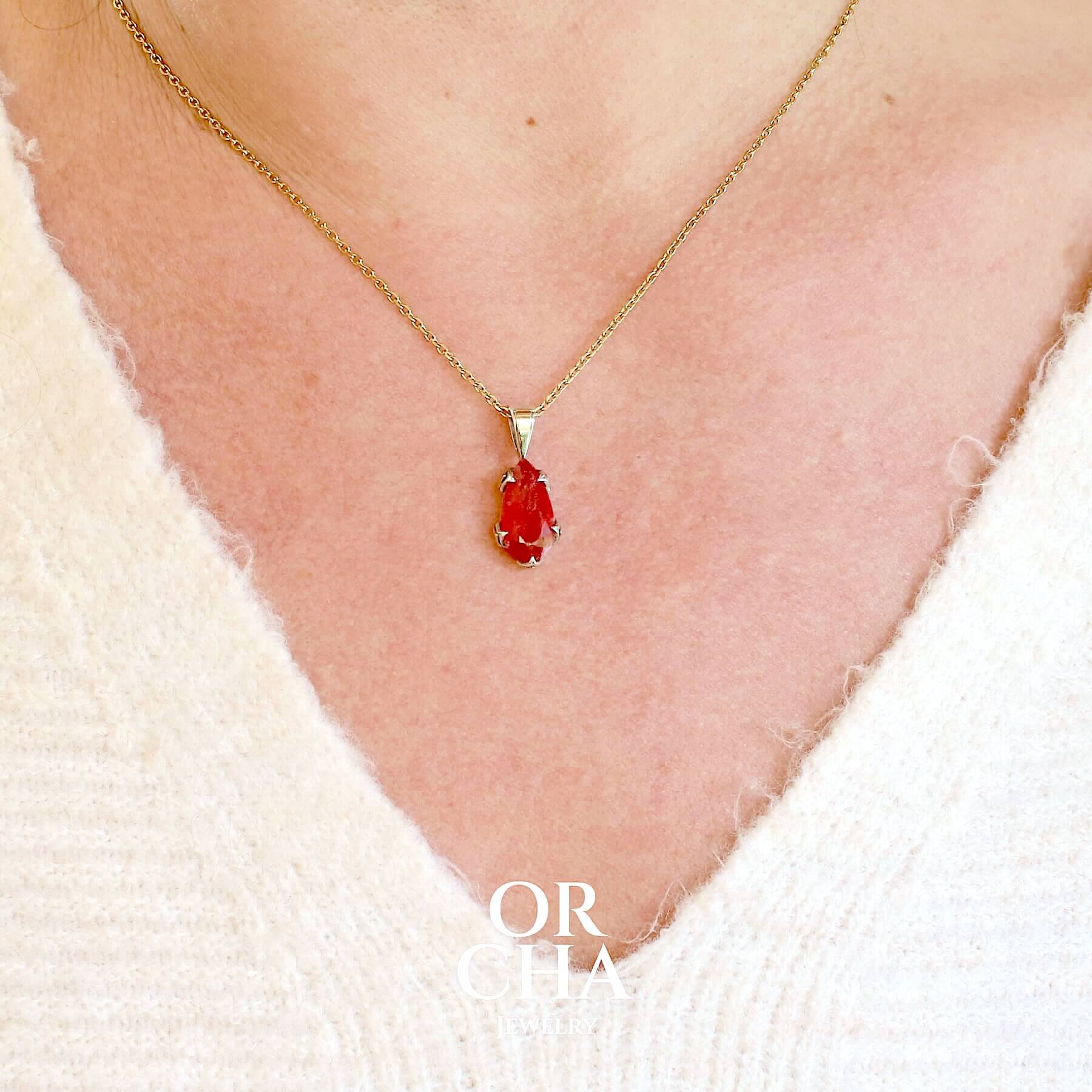 Pendentif pour femme en or jaune massif  9k serti d'une Rhodonite de qualité gemme. Pierre de couleur rouge coquelicot, transparente à inclusions. Pierre naturelle, ovale, taillée en cabochon facetté sur toute sa surface. Bijoux unique, éthique et durable présenté dans un coffret de notre marque, prêt à offrir. Livraison offerte, certificat d'authenticité, service client
