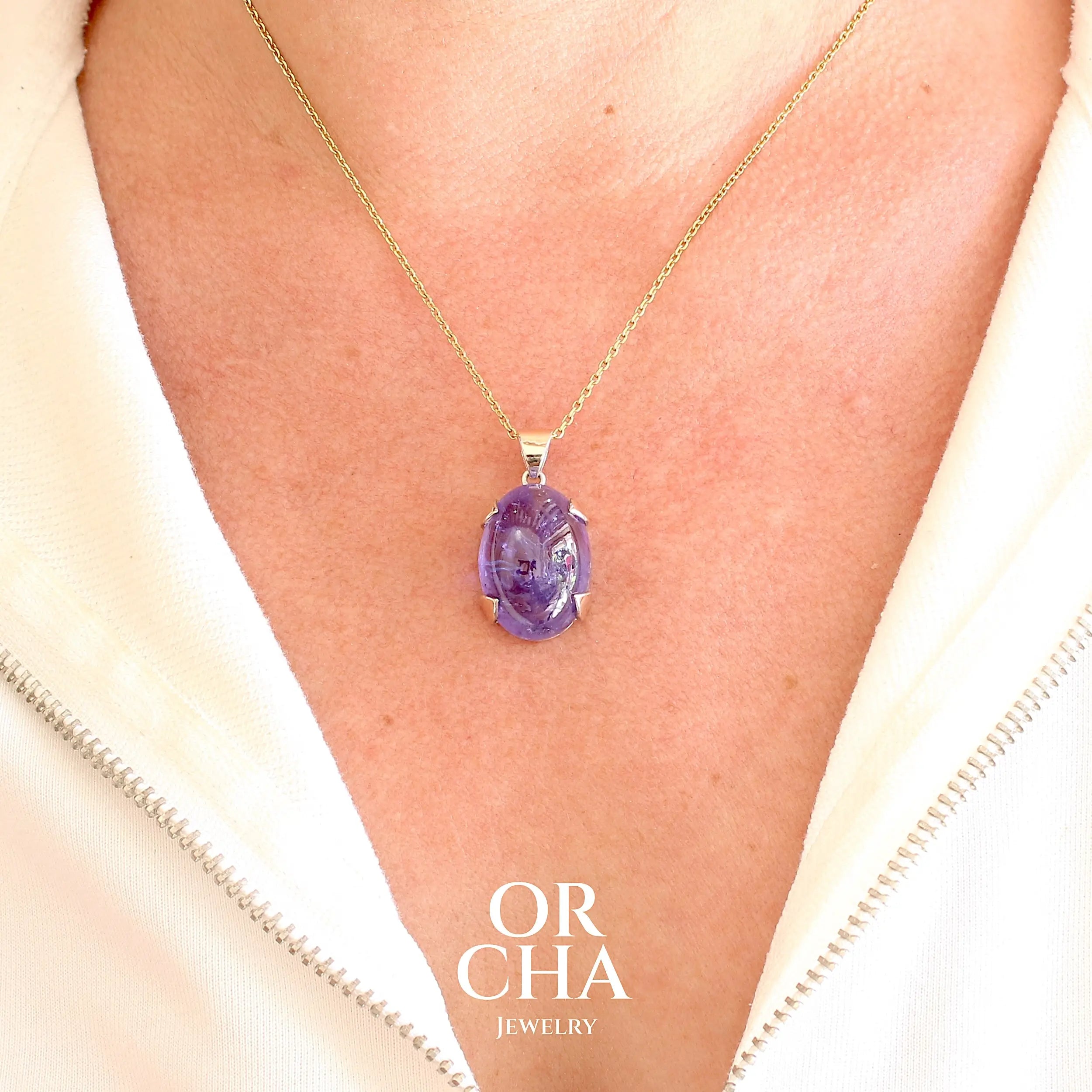 pendentif sur modèle, pour femme en or 9k et argent massif serti d'un cabochon de Tanzanite de 46,3 carats, de couleur bleu lavande foncé profond et intense. Pierre transparente présentant des inclusions. Pierre ayant subit un traitement de chauffe, traitement admis et fréquent en gemmologie pour ce type de pierre . Bijoux unique, éthique et durable présenté dans un coffret de notre marque, prêt à offrir. Livraison offerte, certificat d'authenticité, service client.