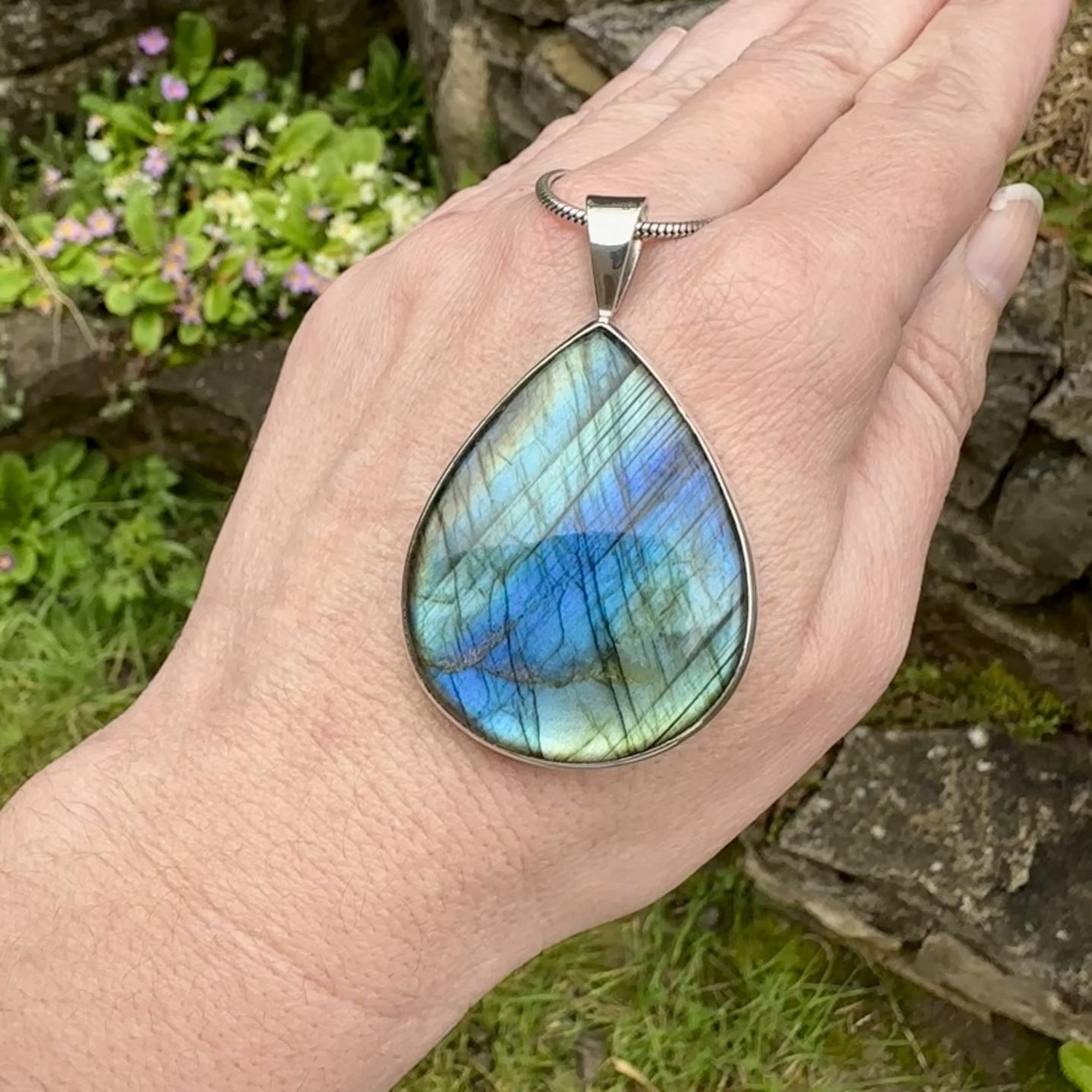 Pendentif pour femme en argent massif sertie d'une labradorite aux reflets bleus, bronzes et or selon la lumière. Pierre facettée naturelle translucide présentant des inclusions fréquents sur ce type de pierre. Bijoux unique, éthique et durable présenté dans un coffret de notre marque, prêt à offrir. Livraison offerte, certificat d'authenticité, service client.
