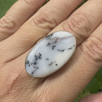 Bague pour femme en argent massif sertie d'un cabochon d'agate dendritique de couleur blanche et noire. Pierre de forme ovale de qualité translucide à inclusions paysages de manganèse contrastées. Bijou unique réalisée en taille 58,5 par Orcha Jewelry