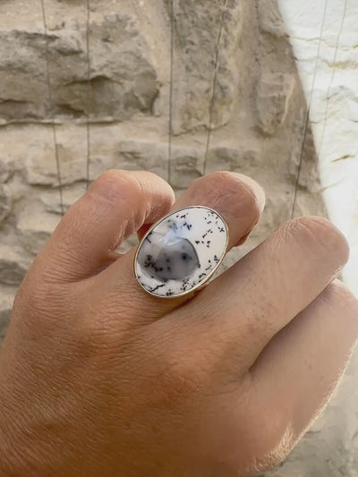 Bague pour femme en argent massif sertie d'un cabochon ovale d'agate dendritique de couleur blanc pur et noir. Pierre paysage opaque translucide à inclusions de dendrites de manganèse noires contrastées. Bijou unique réalisée en taille 52 par Orchajewelry