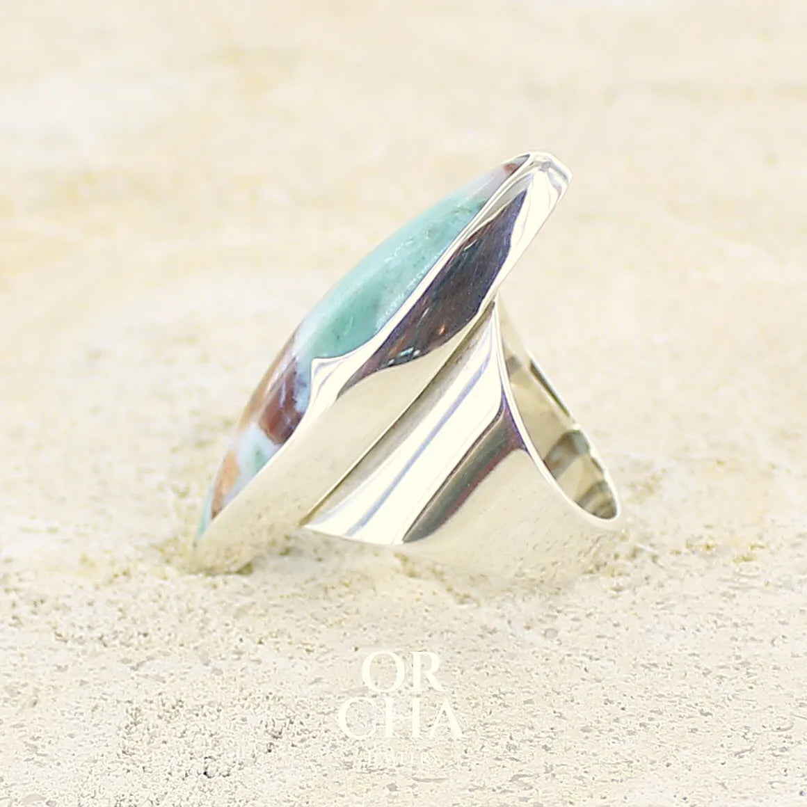 Profil Grande Bague marquise pour femme en argent massif, sertie d'un cabochon de calcédoine bleue verte et marron. Pierre cabochon de qualité opaque. Bijoux unique réalisé en taille 57,5 par Orcha Jewelry